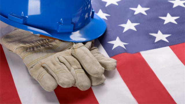 Construction hat and gloves resting on an American flag