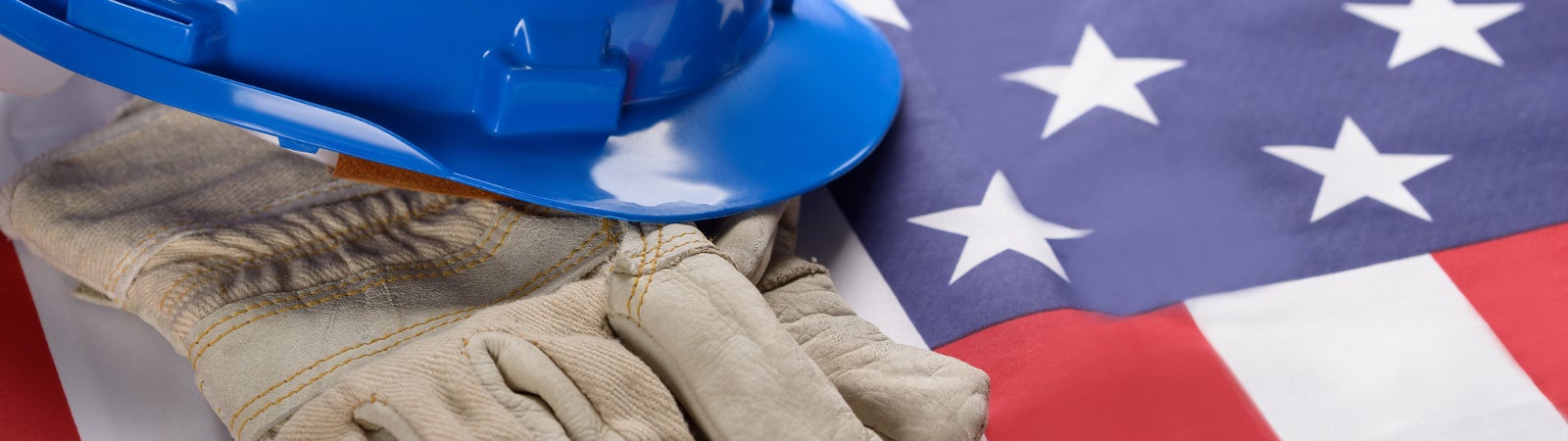 Construction hat and gloves resting on an American flag