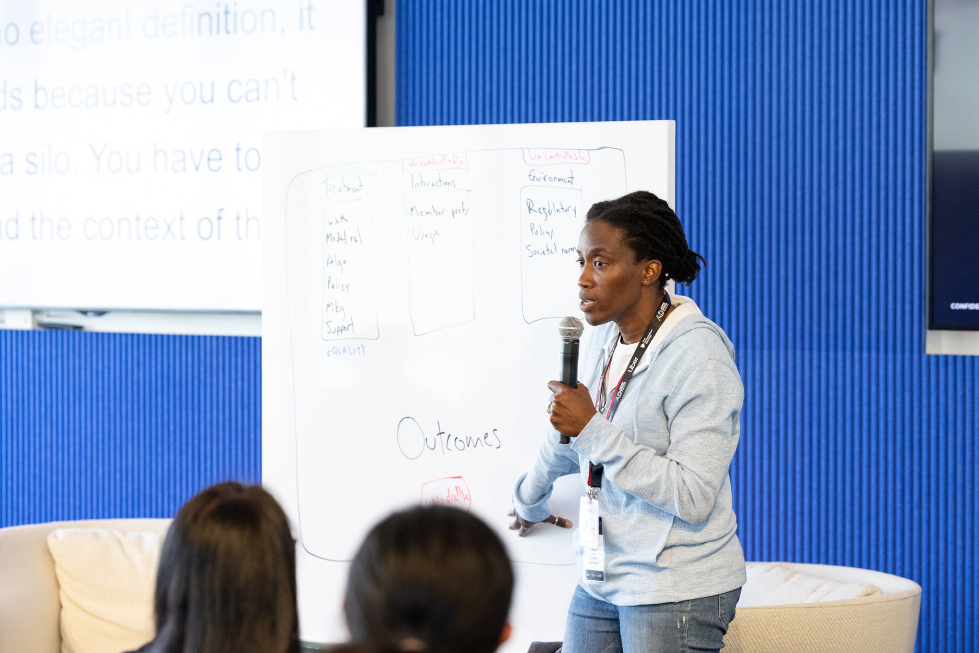 A photo of someone presenting at a meeting.